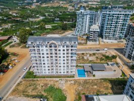 Новая квартира 1+1 в Махмутларе с панорамным видом на горы